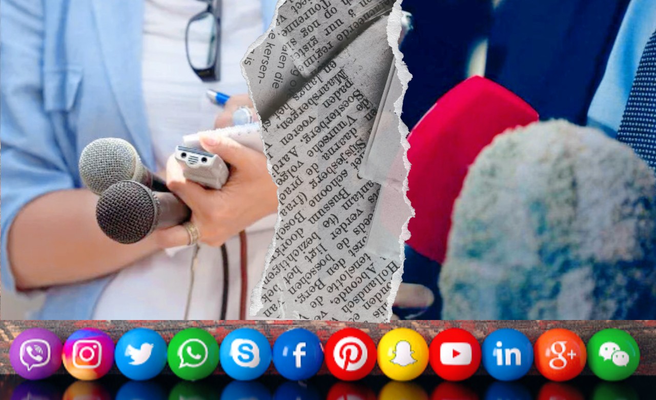 A imagem mostra uma montagem que representa o jornalismo tradicional e o impacto das redes sociais. À esquerda, aparece uma pessoa segurando dois microfones e um gravador, com uma caneta na outra mão, sugerindo a prática jornalística. No centro, há uma faixa vertical de jornal impresso rasgado, dividindo a cena em duas partes. À direita, aparecem microfones coloridos, como os usados em coletivas de imprensa. Na parte inferior da imagem, está uma fileira de ícones de redes sociais em círculos coloridos, incluindo Viber, Instagram, Twitter, WhatsApp, Skype, Facebook, Pinterest, Snapchat, YouTube, LinkedIn, Google Plus e WeChat.